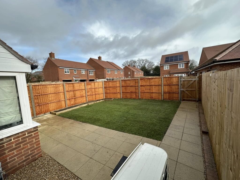 Reclaimed York stone with gravel paths and traditional chestnut paling in a Streatley country cottage garden, authentically restored by AJR Landscaping.