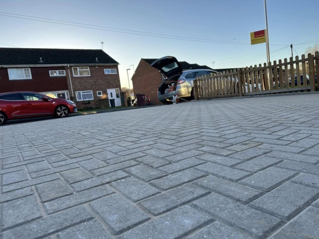 Tegula block paving with contrasting borders and close-board acoustic fencing in a busy Spencers Wood property, professionally installed by AJR Landscaping.