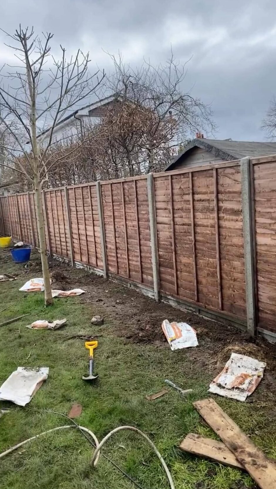 Sandstone circle patio with brick border and feather-edge fence panels for semi-detached gardens in Theale and Berkshire