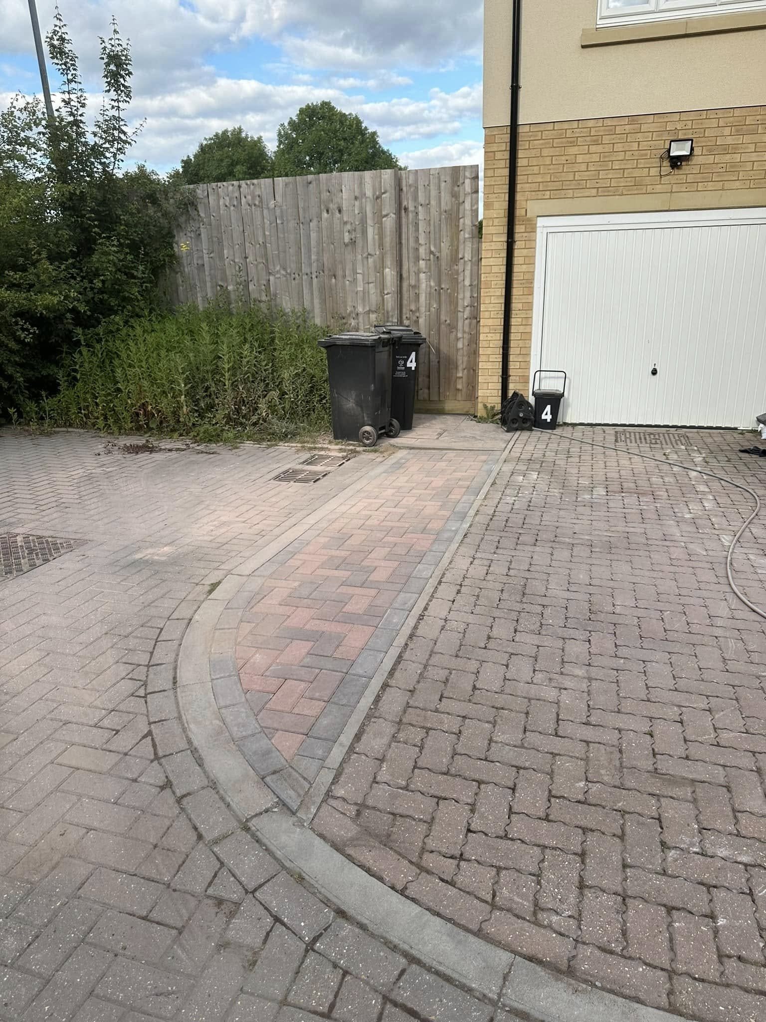 Granite sett driveway with matching pillars and ornamental iron gates in a Crowthorne detached property, impressively constructed by AJR Landscaping.