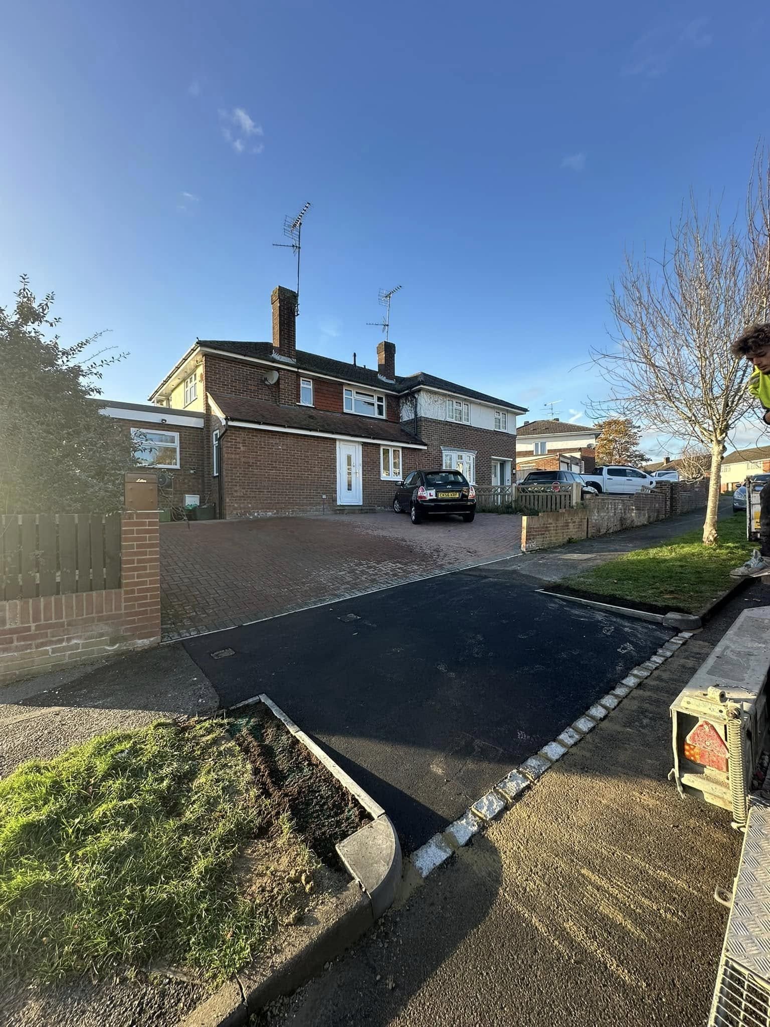 Natural stone crazy paving with alpine rockery and timber post fencing for village gardens in Sonning and Berkshire