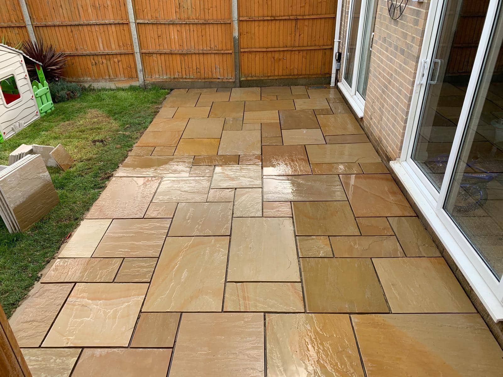 Flagstone paving with raised planters and lattice trellis fencing for riverside gardens in Purley-on-Thames and Berkshire