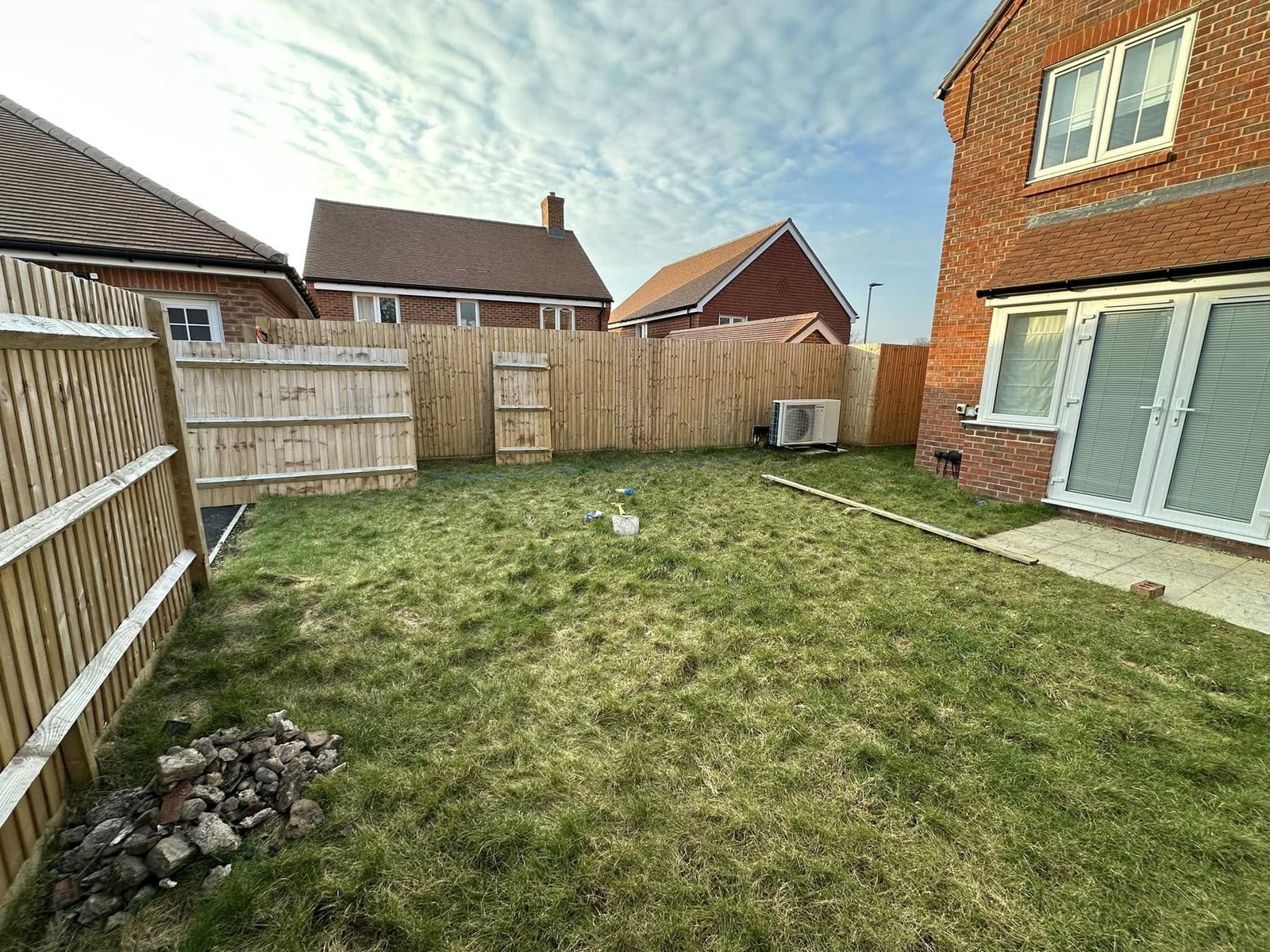 Sandstone circle with radiating brick patterns and decorative railings for town gardens in Newbury and Berkshire