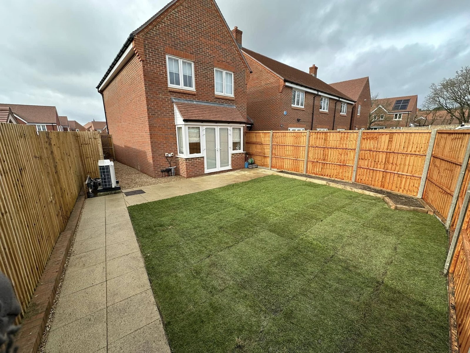 Travertine paving with integrated lighting and wrought iron fencing for luxury gardens in Bracknell Forest and Berkshire