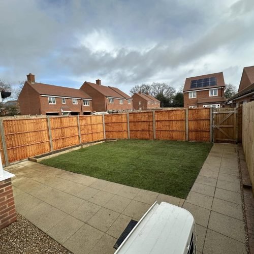 Reclaimed York stone with gravel paths and traditional chestnut paling in a Streatley country cottage garden, authentically restored by AJR Landscaping.