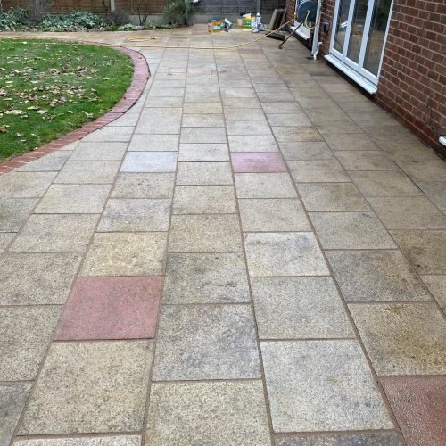 Premium natural stone patio with elegant herringbone pattern in Reading garden. Expert installation by AJR Landscaping for outdoor entertaining spaces.